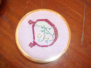 Decorated initial in needlepoint as a pin box made for Tracy in one of her earlier medieval roles