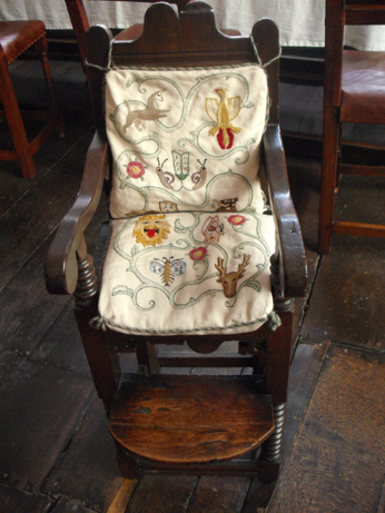 Scrolling flower and fruit motifs on the cushions