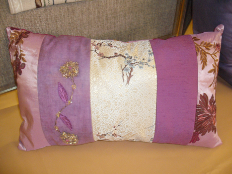 A cushion with embroidery and beading