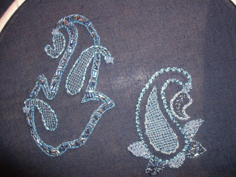 The finished piece still in its hoop - two Paisley inspired motifs
