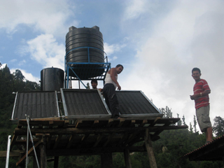 The water butt and solar panels for heating the shower water